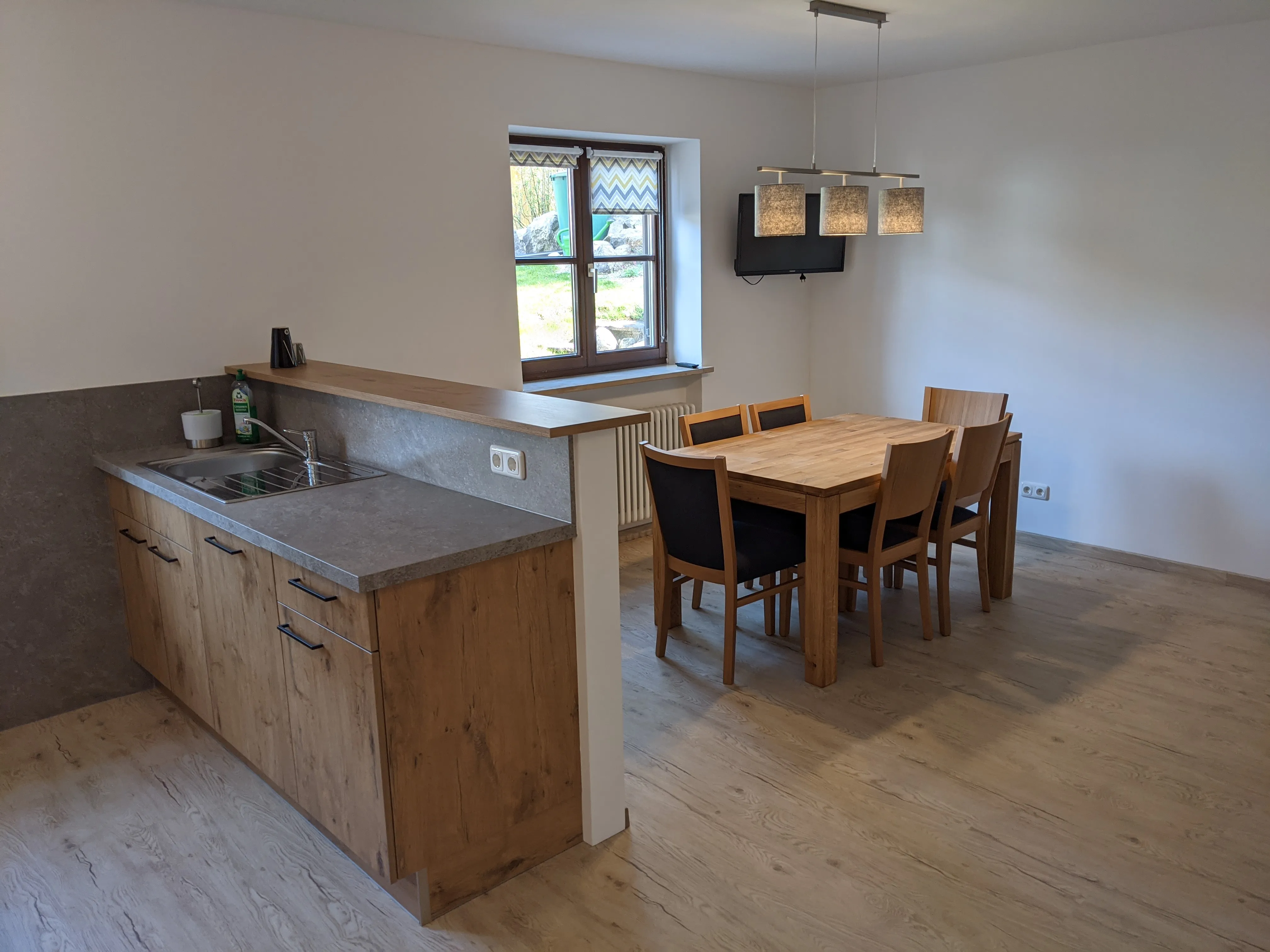 Living and dining area with open kitchen and mountain view
